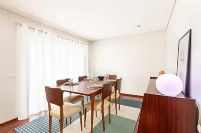 a dining room with a table and chairs at D&S - Family Apartments II in Porto