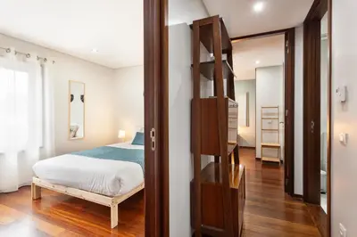 a bedroom with a bed and a ladder in a room at D&S - Family Apartments II in Porto