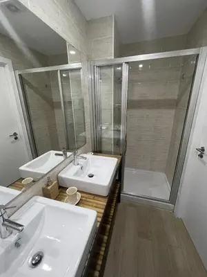 a bathroom with two sinks and a shower and a tub at Portoo Blue Apartments - Douro in Vila Nova de Gaia