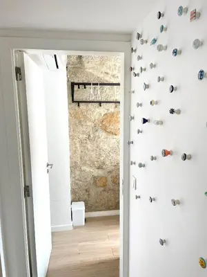 a room with a wall with shoes on the wall at Portoo Blue Apartments - Douro in Vila Nova de Gaia