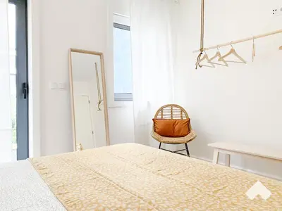 a bedroom with a bed and a chair and a table at The Wondrous Central Apartment in Porto