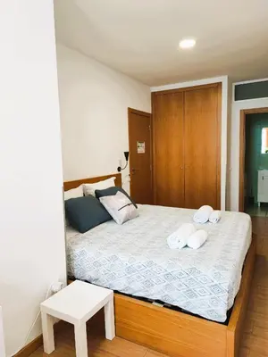a bedroom with a bed with towels on it at Get Cozy in Porto