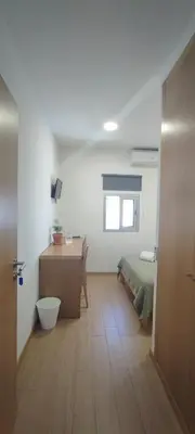 a room with a bed and a desk in a room at Get Cozy in Porto