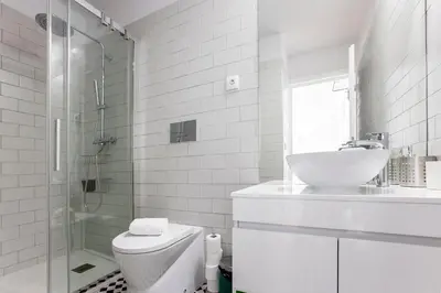 a white bathroom with a sink and a toilet at Flux Art Studio w/ AC & Balcony by LovelyStay in Porto