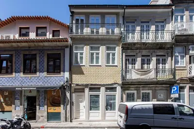 a van parked in front of a row of buildings at Flux Art Studio w/ AC & Balcony by LovelyStay in Porto