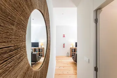 a mirror in the hallway of a living room at Central Studio with Pool & Patio by LovelyStay in Porto