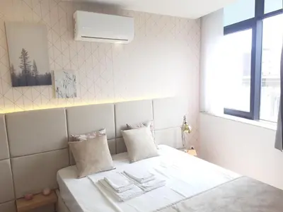 a bedroom with a bed with white sheets and a window at 3 Bedrooms Central Apartment with garage by Great&Cosy in Porto