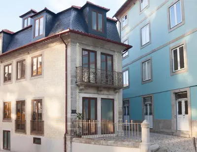 a building with a balcony on the side of it at Framer's House - Authentic Downtown in Porto