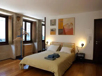 a bedroom with a bed with two towels on it at Framer's House - Authentic Downtown in Porto