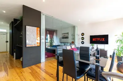 a dining room and living room with a table and chairs at Sunny Oporto, Trindade Balcony in Porto