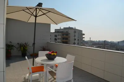 a table and chairs on a balcony with an umbrella at Musical View in Porto