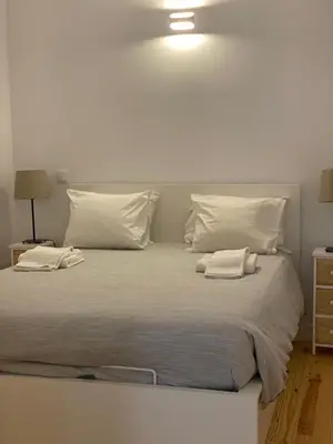 a large white bed with two pillows on it at Quiet Apartment with Terrace in the Heart of Porto by Great&Cosy in Porto