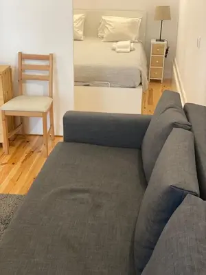 a living room with a couch and a bed at Quiet Apartment with Terrace in the Heart of Porto by Great&Cosy in Porto