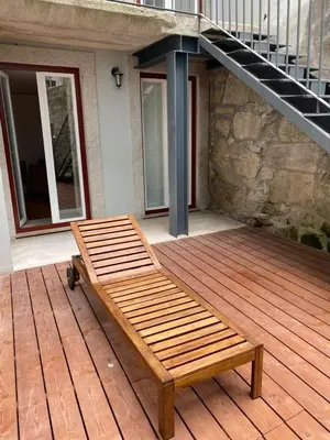a wooden bench sitting on top of a wooden deck at Quiet Apartment with Terrace in the Heart of Porto by Great&Cosy in Porto