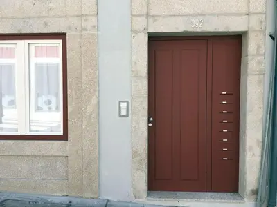a red door and a window on a building at Quiet Apartment with Terrace in the Heart of Porto by Great&Cosy in Porto