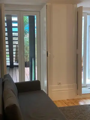 a living room with a couch and a sliding glass door at Quiet Apartment with Terrace in the Heart of Porto by Great&Cosy in Porto