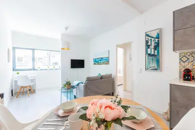 a living room with a table and a couch at Casa Azul @ Jardim do Morro by BnBird in Vila Nova de Gaia