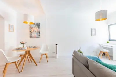 a living room with a couch and a table at Casa Azul @ Jardim do Morro by BnBird in Vila Nova de Gaia