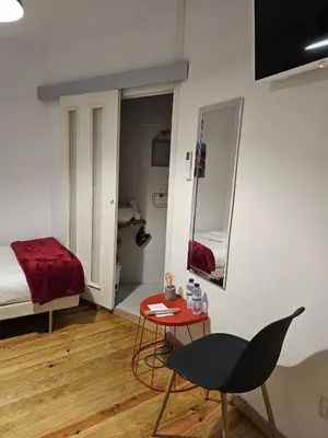 a room with a bed and a table and a chair at Douro View House Ribeira in Porto