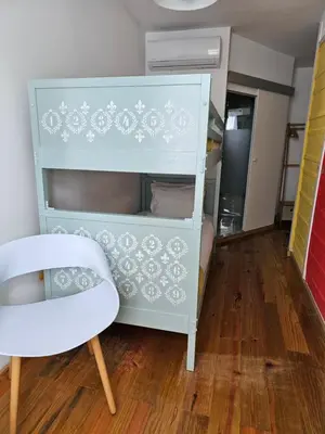 a blue cabinet with a chair in a room at Douro View House Ribeira in Porto
