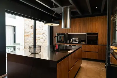 a kitchen with a black counter top and wooden cabinets at Arty Porto in Porto
