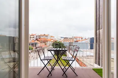a balcony with two chairs and a table on a balcony at ON Apartments - Lapa Deluxe in Porto
