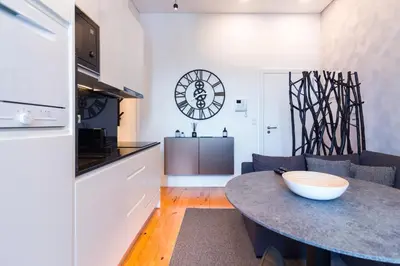 a kitchen and living room with a table in a room at ON Apartments - Lapa Deluxe in Porto