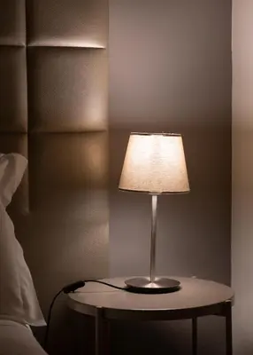 a lamp sitting on a table next to a bed at Gaia Douro Apartment in Vila Nova de Gaia