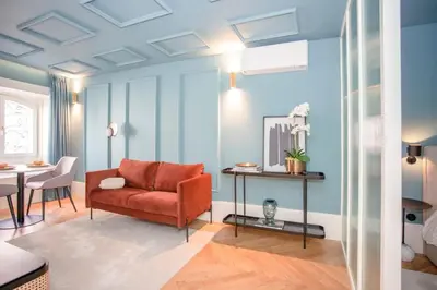 a living room with a red couch and a table at Liiiving in Porto - Ribeira Design Apartment in Porto
