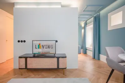 a living room with a table with a laptop on it at Liiiving in Porto - Ribeira Design Apartment in Porto
