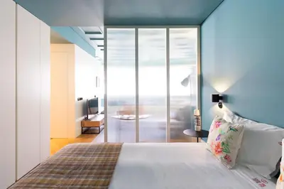 a bedroom with a bed with a view of the ocean at HM - Infante Riverside Apartment M in Porto