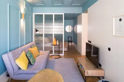 a living room with a purple couch and a television at HM - Infante Riverside Apartment M in Porto