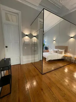 a bedroom with a bed and a large glass wall at Formosa Apartments in Porto