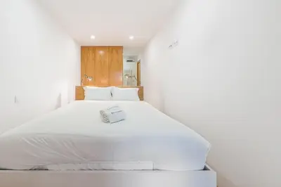 a white bed with a box on it in a room at GuestReady - Green Bay Garden in Porto