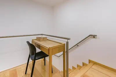 a desk and a chair in front of a wall at GuestReady - Green Bay Garden in Porto