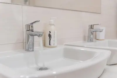 a bathroom with two sinks and a bottle of soap at GuestReady - Green Bay Garden in Porto