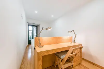 a desk with two lamps on it in a room at GuestReady - Green Bay Garden in Porto