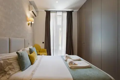 a bedroom with a large bed with towels on it at BOUTIQUE Rentals-Art & Charm II Apt w/ Terrace in Porto