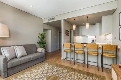 a living room with a couch and a kitchen at Legends House by Sweet Porto in Porto