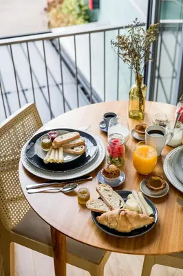 a table with plates of breakfast food on it at Legends House by Sweet Porto in Porto