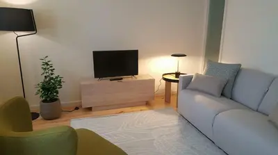 a living room with a couch and a tv at GuestReady - Catorze de Outubro Houses 423 in Vila Nova de Gaia