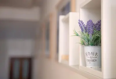 a flower pot with purple flowers on a shelf at GuestReady - Catorze de Outubro Houses 423 in Vila Nova de Gaia