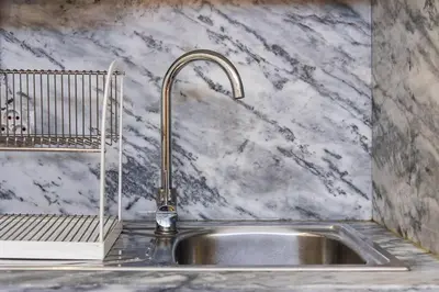 a kitchen sink with a faucet on a counter at GuestReady - Bella's Downtown Apartment in Porto