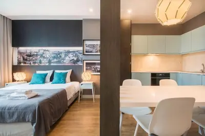 a bedroom with a bed and a table and chairs at 447 Galé Apartment wifi, parking in Porto