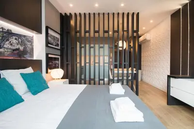 a bedroom with a large bed with blue and white pillows at 447 Galé Apartment wifi, parking in Porto