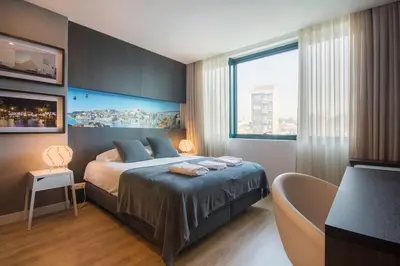 a bedroom with a bed and a large window at 446 Galé Modern Apartment elevator,parking in Porto
