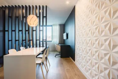 a dining room with a table and chairs and a wall at 446 Galé Modern Apartment elevator,parking in Porto