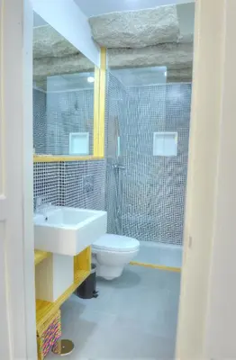a bathroom with a sink and a toilet and a shower at Three Houses & Bedrooms in Porto