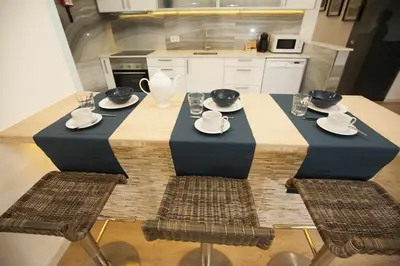 a table in a kitchen with plates and dishes on it at Golden & Blue House, o seu novo espaço no Porto in Porto