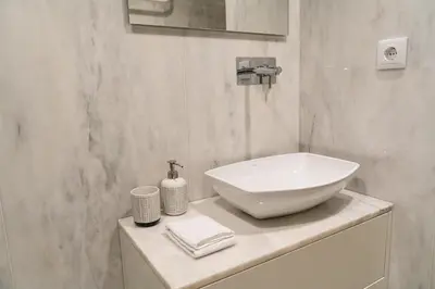 a bathroom with a white sink on a counter at Shiny Porto in Porto
